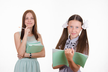 Image showing Trainee writes in a notebook, the teacher pleased