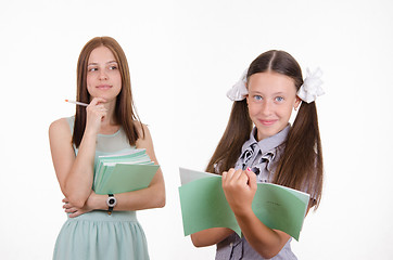 Image showing Trainee writes in a notebook, answering homework