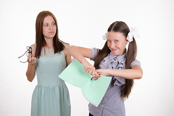 Image showing Trainee tears notebook in front of the teacher