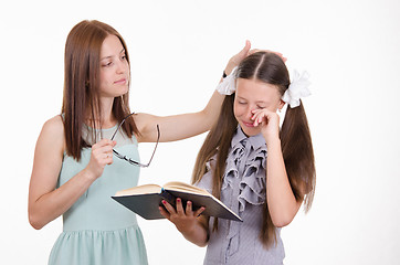 Image showing Teacher calms distressed student