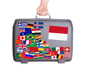 Image showing Used plastic suitcase with stickers