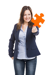 Image showing Business woman holding a puzzle piece