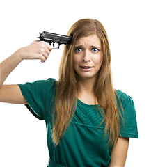 Image showing Pointing a gun on herself