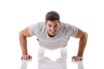 Image showing Handsome young man making pushups