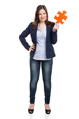 Image showing Business woman holding a puzzle piece