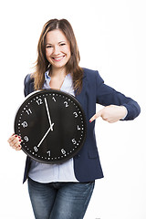 Image showing Business woman holding a big clock