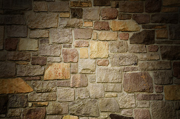 Image showing Masonry Wall of Multicolored Stone Lit Dramatically