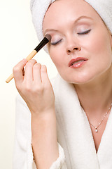 Image showing Putting on makeup