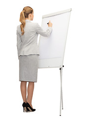 Image showing businesswoman or teacher with marker from back