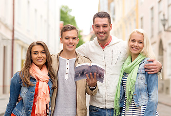 Image showing group of friends with city guide exploring town