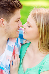 Image showing smiling couple touching noses in park