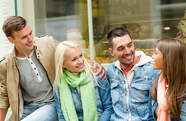 Image showing group of smiling friends walking in the city