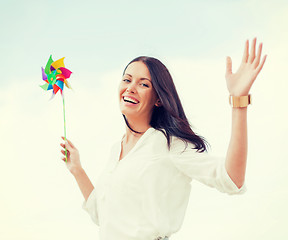 Image showing girl with windmill toy on the beach