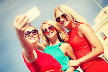 Image showing smiling girls taking photo with smartphone camera