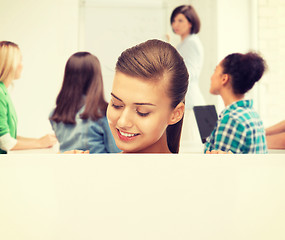 Image showing smiling student girl with white blank board