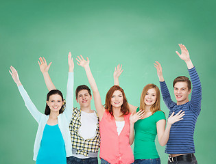 Image showing group of smiling students waving hands