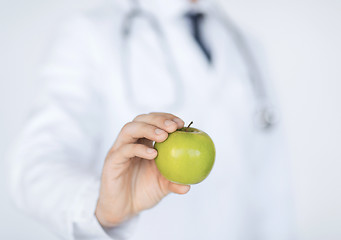 Image showing male doctor with green apple