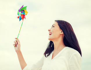 Image showing girl with windmill toy on the beach