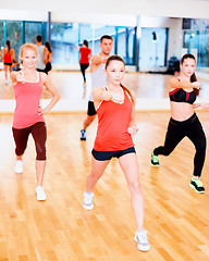 Image showing group of concentrated people exercising in the gym