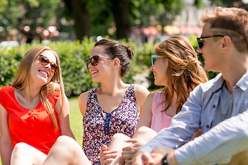 Image showing group of smiling friends outdoors sitting in park