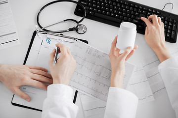 Image showing two doctors prescribing medication