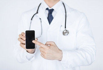 Image showing doctor pointing at smartphone