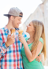 Image showing smiling couple with ice-cream in city