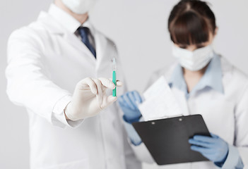 Image showing doctors with syringe