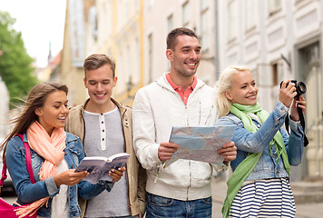 Image showing group of friends with city guide, map and camera