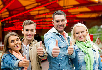 Image showing group of smiling friends showing thumbs up