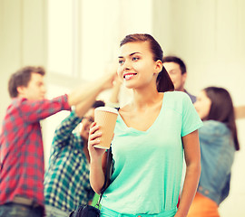 Image showing student holding take away coffee cup in college