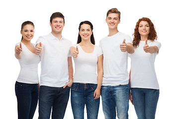 Image showing smiling teenagers in t-shirts showing thumbs up