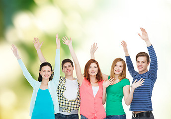 Image showing group of smiling students waving hands