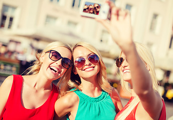 Image showing girls taking picture with camera in the city