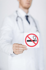 Image showing male doctor holding no smoking sign