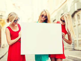 Image showing three happy blonde women with blank white board