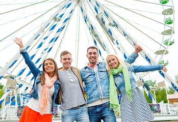 Image showing group of smiling friends waving hands