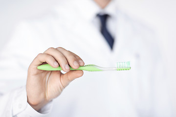 Image showing dentist or stomatologist holding toothbrush