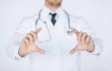 Image showing doctor with holding something with hands