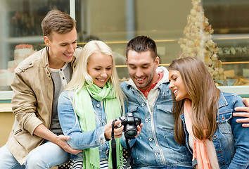 Image showing group of smiling friends with digital photocamera