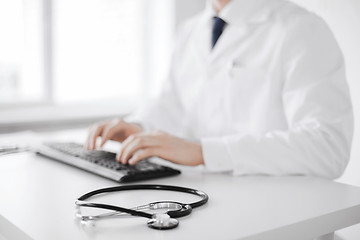 Image showing male doctor typing on the keyboard