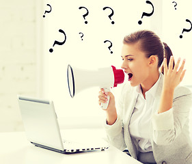 Image showing strict businesswoman shouting in megaphone