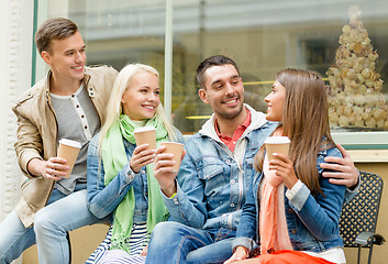 Image showing group of smiling friends with take away coffee