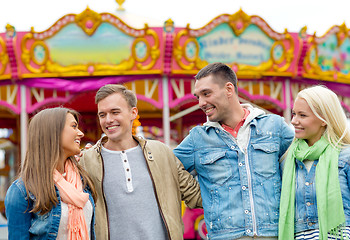 Image showing group of smiling friends in amusement park