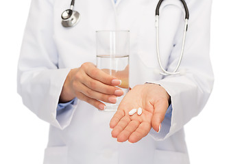 Image showing close up of doctor offering pills and water