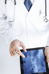 Image showing male doctor holding tablet pc with x-ray