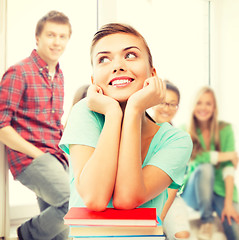 Image showing happy smiling student girl with books at school