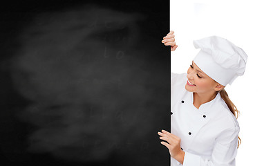 Image showing smiling female chef with white blank board