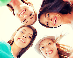 Image showing faces of girls looking down and smiling