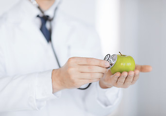 Image showing male doctor with green apple and stethoscope